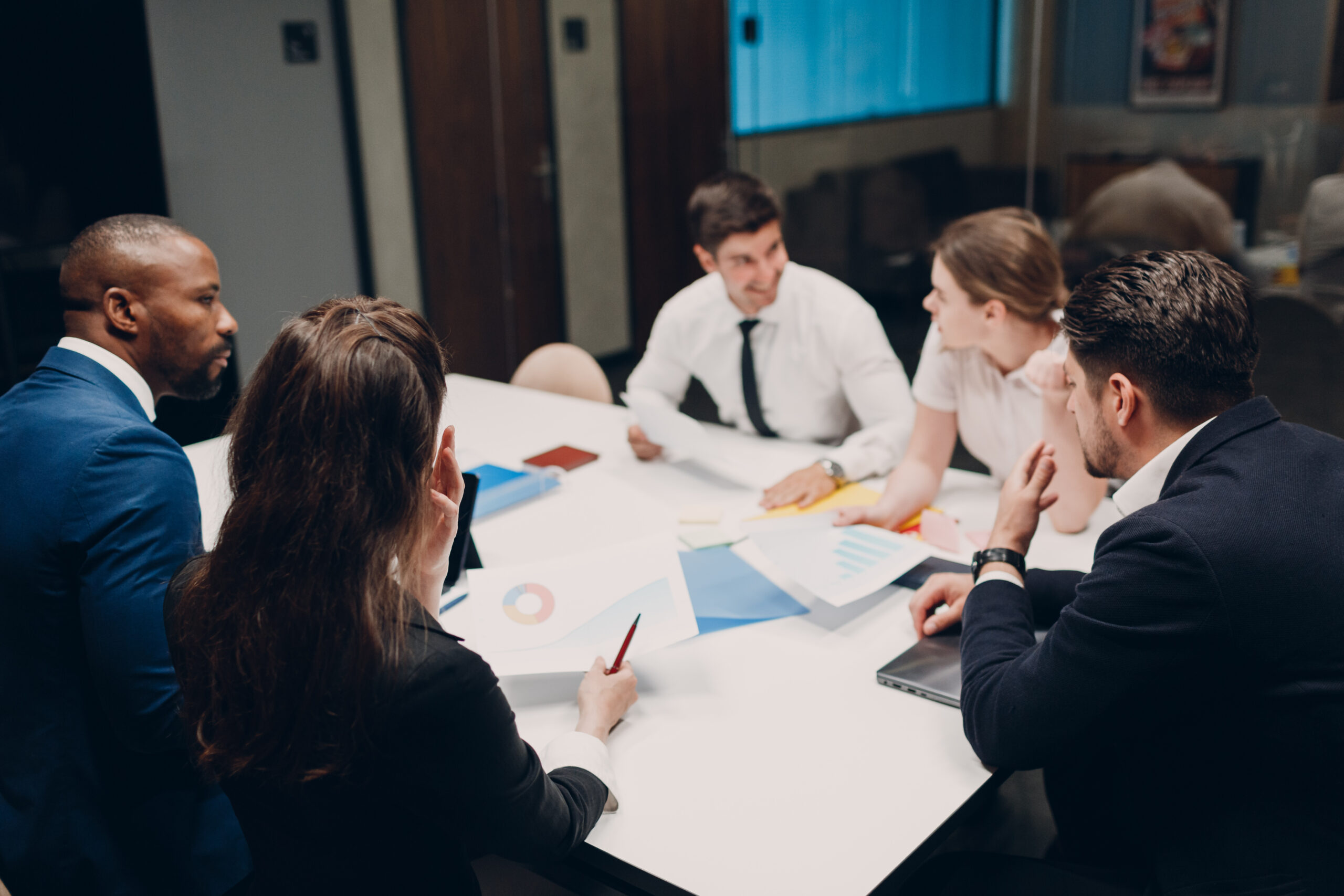 Businessman and businesswoman team at office meeting. Business people group conference discussion sit at table with boss man and woman.
